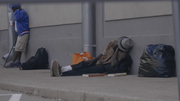 A homeless person being helped through the use of technology.