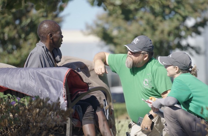 A homeless person being helped through the use of technology.