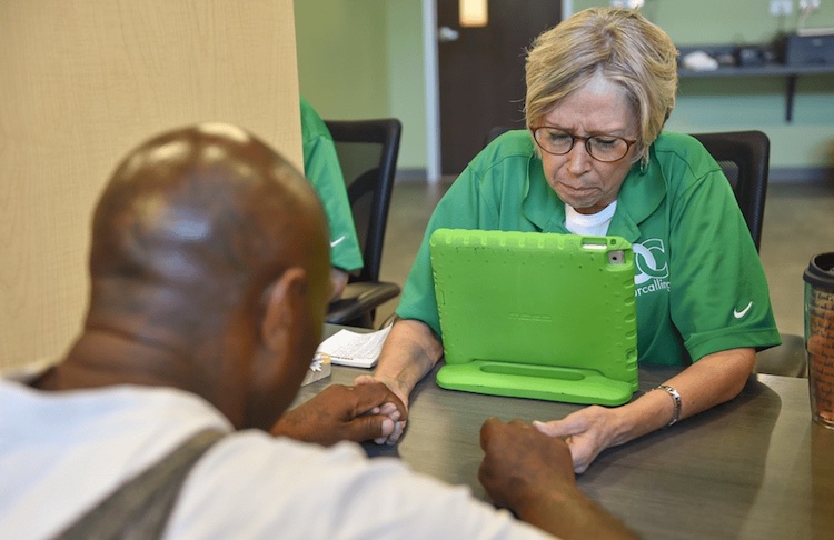 A homeless person being helped through the use of technology.