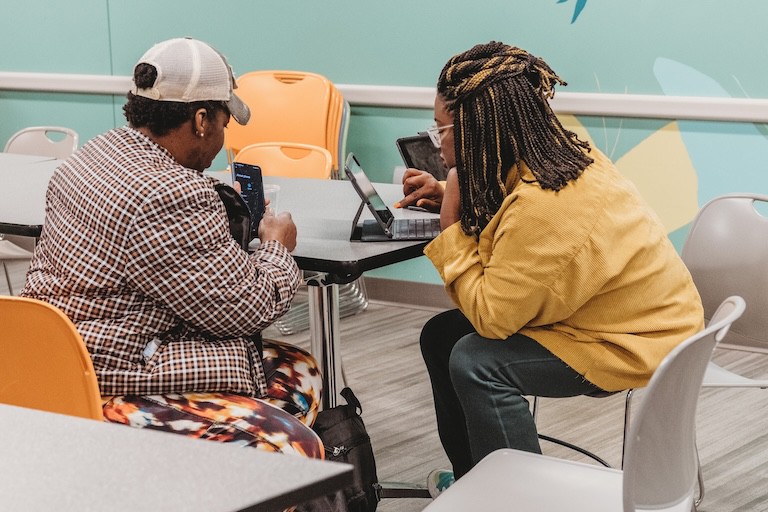 A homeless person being helped through the use of technology.